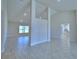 Open-concept living room with high ceilings, recessed lighting, and tile floors creating a modern, airy space at 5280 Tennessee Ridge Ct, Auburndale, FL 33823