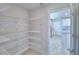 Walk-in pantry with wire shelving providing ample storage space in an organized fashion at 5280 Tennessee Ridge Ct, Auburndale, FL 33823