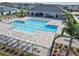 Large community pool with shaded seating area and lounge chairs; beautiful landscaping at 5600 Siltstone St, Lakeland, FL 33811