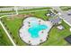 Aerial view of a clover-shaped community pool surrounded by lounge chairs and lush landscaping at 5600 Siltstone St, Lakeland, FL 33811