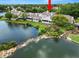 Lovely backyard showcasing a peaceful lake, beautiful rock landscaping, and a home with a screened porch at 1144 Waterfall Ln # 26, Lakeland, FL 33803