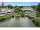 Stunning backyard view featuring a serene lake with rock waterfall and lush landscaping at 1144 Waterfall Ln # 26, Lakeland, FL 33803