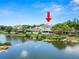 Scenic backyard view with a calm lake, a home with a screened-in porch, and manicured landscaping at 1144 Waterfall Ln # 26, Lakeland, FL 33803