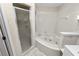 Bathroom featuring a glass shower and corner soaking tub at 1144 Waterfall Ln # 26, Lakeland, FL 33803