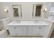 Bathroom featuring double sinks, white cabinets, modern faucets, and tile flooring at 1144 Waterfall Ln # 26, Lakeland, FL 33803