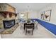 Staged dining room featuring a stone fireplace, wood table set, chandelier, and modern artwork at 1144 Waterfall Ln # 26, Lakeland, FL 33803