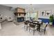 Staged dining room featuring a stone fireplace, wood table set, chandelier, and view to the backyard at 1144 Waterfall Ln # 26, Lakeland, FL 33803