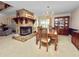 Traditional dining room featuring a stone fireplace, wood table set, chandelier, and built-in china cabinet at 1144 Waterfall Ln # 26, Lakeland, FL 33803