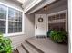 Inviting front entrance with a white door, a wreath, and potted plants at 1144 Waterfall Ln # 26, Lakeland, FL 33803