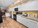 Galley kitchen with granite countertops and white cabinets at 1144 Waterfall Ln # 26, Lakeland, FL 33803