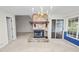 Living room with a stone fireplace, mantle and deck access through sliding doors at 1144 Waterfall Ln # 26, Lakeland, FL 33803