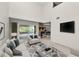 Bright living room with stone fireplace, deck access, and modern furnishings at 1144 Waterfall Ln # 26, Lakeland, FL 33803