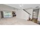 Spacious living area featuring a stone fireplace, stairs, and access to a deck at 1144 Waterfall Ln # 26, Lakeland, FL 33803