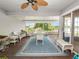 Inviting screened porch featuring comfortable seating and a table with scenic lake views at 1144 Waterfall Ln # 26, Lakeland, FL 33803