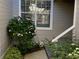 Side entrance with flowering bush and steps leading to the door at 1144 Waterfall Ln # 26, Lakeland, FL 33803