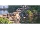 Scenic view of a community water feature with cascading waterfalls and lush greenery at 1144 Waterfall Ln # 26, Lakeland, FL 33803