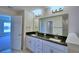 Bathroom featuring double sinks, granite countertops, and access to walk-in closet at 5120 Villa Crest Way, Auburndale, FL 33823