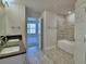 Modern bathroom features double sinks, granite countertops, and a tiled shower over tub at 5120 Villa Crest Way, Auburndale, FL 33823