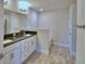 Elegant bathroom featuring double sinks, granite countertops, and a separate tub area at 5120 Villa Crest Way, Auburndale, FL 33823