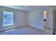 Bedroom with large window and plush carpeting, adjacent to ensuite bath at 5120 Villa Crest Way, Auburndale, FL 33823