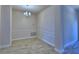 Elegant dining room featuring decorative wainscoting, a chandelier, and wood-look tile flooring at 5120 Villa Crest Way, Auburndale, FL 33823