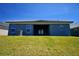 Back exterior view showing windows, patio, roof and an AC unit at 5120 Villa Crest Way, Auburndale, FL 33823