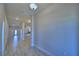 Bright and open hallway with wood-look tile flooring, recessed lighting, and access to the kitchen and other rooms at 5120 Villa Crest Way, Auburndale, FL 33823