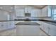 Well-appointed kitchen featuring a center island, stainless steel appliances, and granite countertops at 5120 Villa Crest Way, Auburndale, FL 33823