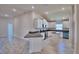 Modern kitchen featuring white cabinets, granite countertops, stainless steel appliances, and an island with bar seating at 5120 Villa Crest Way, Auburndale, FL 33823