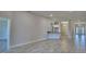 Open-concept living room boasts tile floors, recessed lighting, and seamless flow into the kitchen area at 5120 Villa Crest Way, Auburndale, FL 33823