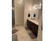 Bathroom featuring double vanity with granite countertop, tiled floor, walk-in shower and neutral colors at 2875 Creeks Crossing Blvd, Lakeland, FL 33810