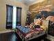Bright bedroom with hardwood floors, sports themed wall art, and abundant natural light at 2875 Creeks Crossing Blvd, Lakeland, FL 33810