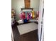 closet featuring open shelving, colorful clothes, and hardwood floors at 2875 Creeks Crossing Blvd, Lakeland, FL 33810