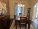 Traditional dining room features hardwood floors, chandelier lighting, and modern design at 2875 Creeks Crossing Blvd, Lakeland, FL 33810