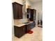 Modern kitchen with stainless steel appliances, granite countertops, and dark wood cabinetry at 2875 Creeks Crossing Blvd, Lakeland, FL 33810