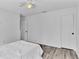 White bedroom with LVP floors, and neutral paint and trim at 7365 Millbrook Oaks Dr, Lakeland, FL 33813