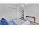 Bright bedroom featuring a ceiling fan, closet, and hardwood floors at 7365 Millbrook Oaks Dr, Lakeland, FL 33813