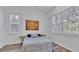 Bright bedroom features two windows and a nautical themed art piece over the bed at 7365 Millbrook Oaks Dr, Lakeland, FL 33813