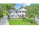 Inviting two-story home with a manicured lawn, black shutters, and fresh landscaping at 7365 Millbrook Oaks Dr, Lakeland, FL 33813
