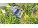 Aerial view of screened-in pool surrounded by lush greenery and mature trees at 7365 Millbrook Oaks Dr, Lakeland, FL 33813