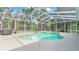 Sparkling pool with a screened enclosure, waterfall, and surrounding patio at 7365 Millbrook Oaks Dr, Lakeland, FL 33813