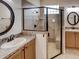 Bathroom featuring a tiled walk-in shower with a glass enclosure and dual sinks at 4536 Grayhawk Dr, Winter Haven, FL 33884