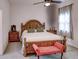 Cozy bedroom featuring a classic wooden bed frame, plush carpeting, and natural lighting at 4536 Grayhawk Dr, Winter Haven, FL 33884