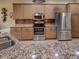 Modern kitchen showcasing stainless steel appliances, granite countertops, and ample cabinet space at 4536 Grayhawk Dr, Winter Haven, FL 33884