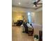Inviting living area featuring a dining table, tile floors, and a comfortable leather sofa at 4536 Grayhawk Dr, Winter Haven, FL 33884