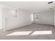 Spacious carpeted bedroom with large window and neutral walls at 5440 Se 127Th Ln, Belleview, FL 34420