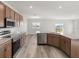 Modern kitchen with wood cabinets, granite counters, and stainless steel appliances at 5440 Se 127Th Ln, Belleview, FL 34420
