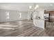 Open living area with light wood-look floors and island kitchen at 5440 Se 127Th Ln, Belleview, FL 34420