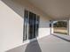 Covered patio with sliding glass doors and view to backyard at 5440 Se 127Th Ln, Belleview, FL 34420