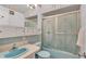 Bathroom with blue toilet, sink, medicine cabinet and mosaic tile surrounding at 1600 W Lake Parker Dr # A2, Lakeland, FL 33805